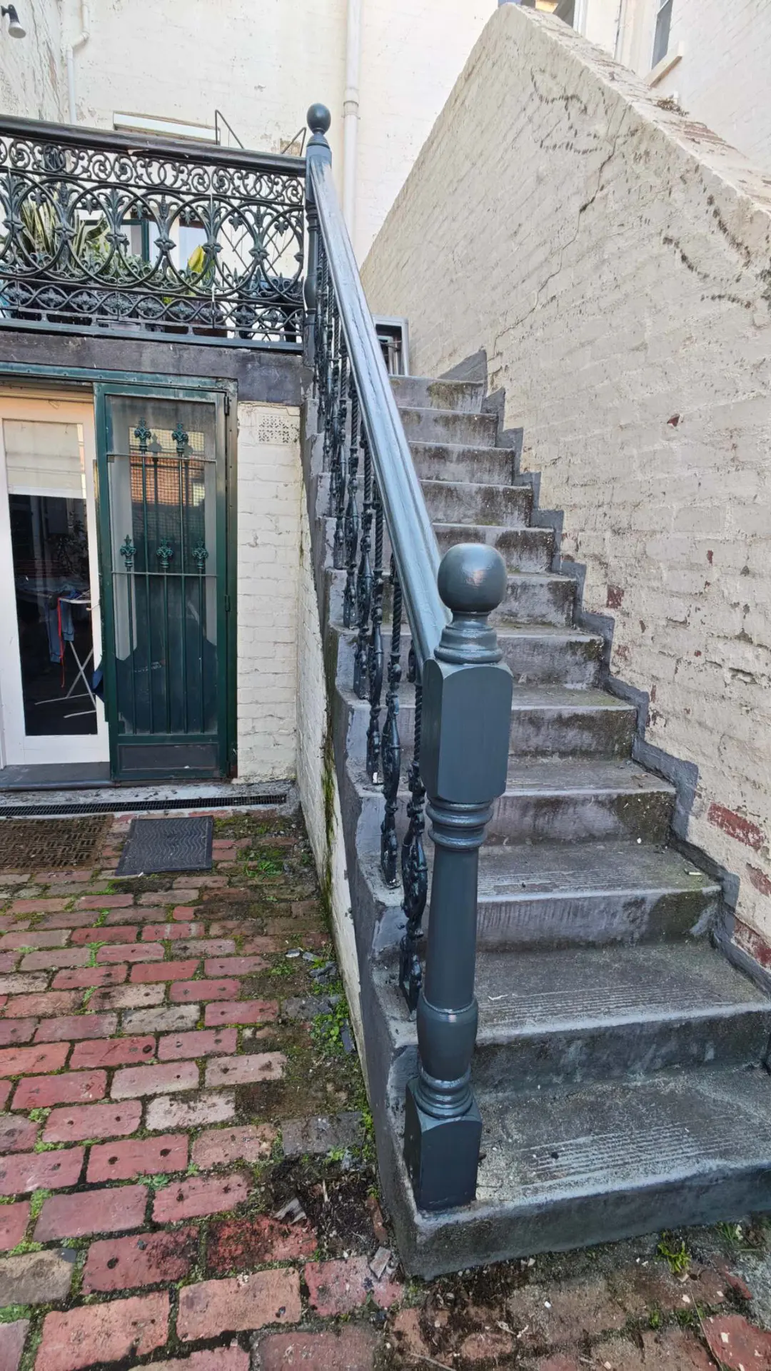 Outdoor stair handrail and ornamental balustrade after repair and refinishing